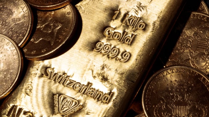 Gold inches lower as dollar gains ground