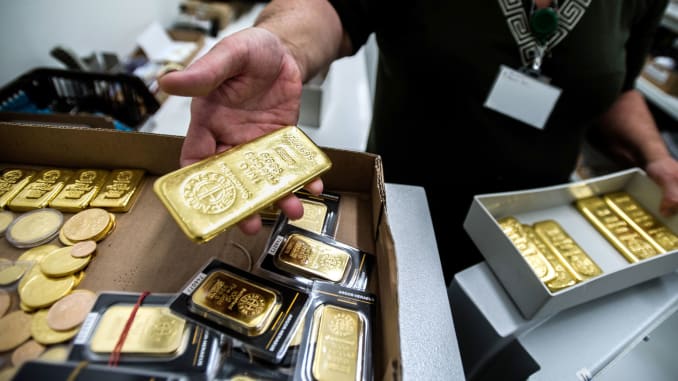 Gold ticks higher on softer dollar, mounting virus woes